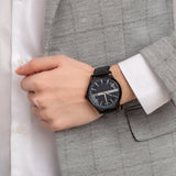 Man wearing black wristwatch, detail shot