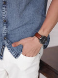 Man's wrist with watch and denim shirt