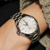 Silver wristwatch on wrist