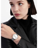 Woman wearing silver wristwatch