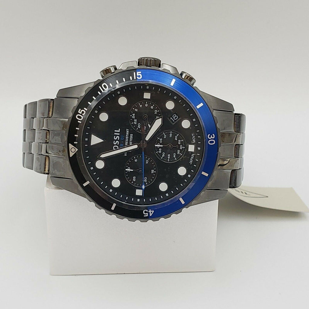 Fossil watch with blue bezel on white stand
