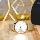 Armani Exchange Lola AX5536 women's watch, gold, on wooden surface