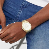 Gold wristwatch on wrist, pzvn217g...