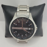 Armani Exchange men's watch on black pillow