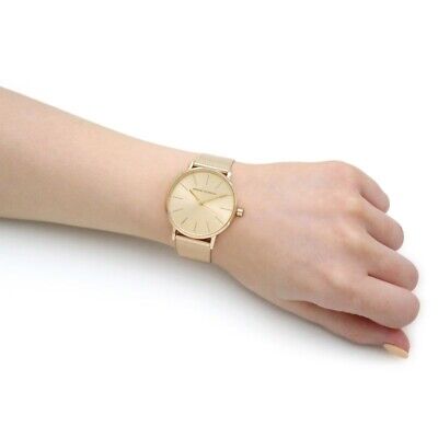 Gold wristwatch on wrist