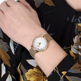 Guess W0647L7 gold watch with bracelet on wrist