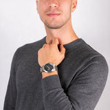 Man wearing silver fashion watch with bracelet