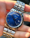 Tudor watch with blue dial, 04bfeb2e, displaying Friday and date.