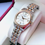 Tissot watch with silver and gold band, on display.