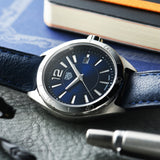 TAG Heuer watch with blue face and leather strap