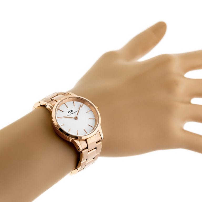 Rose gold wristwatch on a wrist.