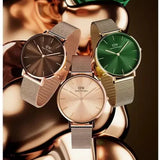 Three Daniel Wellington watches with different colored faces.