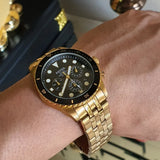 Gold Fossil watch on wrist