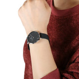 Wrist watch on a person's arm.