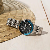 Fossil watch with blue bezel on woven surface