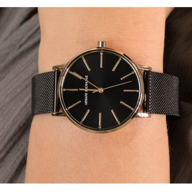 Wrist with a black Armani Exchange watch.