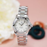 Silver wristwatch with white face.