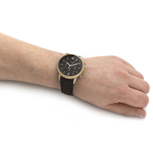 Fossil watch on wrist, black and gold design, 3231468b26461e6898aecacf35a339ad