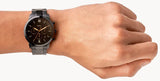 Wrist with a dark watch.