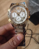 Gold and silver Guess wristwatch with gemstones.