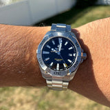 Wrist with a silver wristwatch.