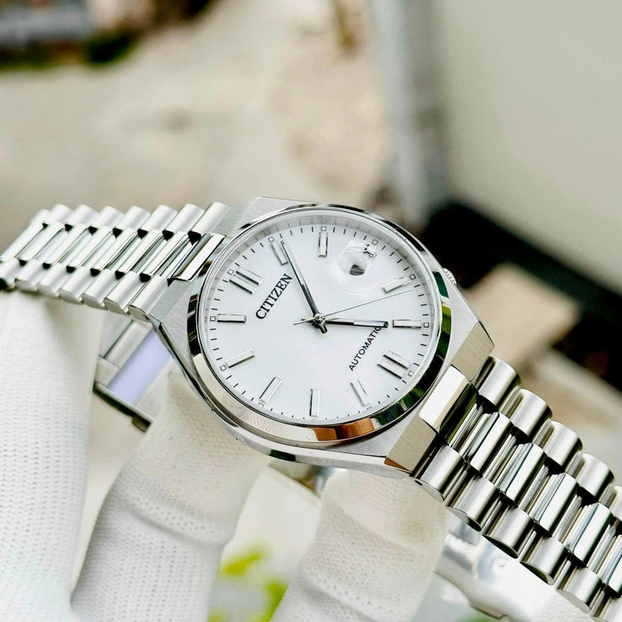 Citizen silver wristwatch with white face.