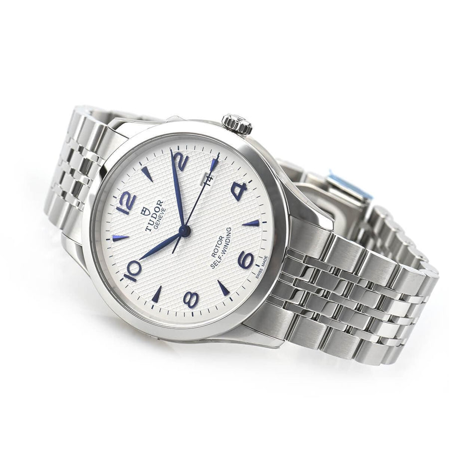 Tudor watch with white face and stainless steel band