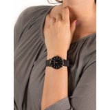 Woman's wrist with a black watch.