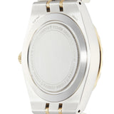 Back of a silver and gold wristwatch.