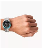 Wrist with a silver watch showing time.