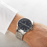 Man's watch 45wgfdasg style with silver band and black face.