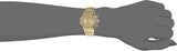 Gold wristwatch on wrist.