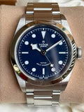 Silver wristwatch with a blue face.