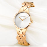 Gold Calvin Klein wristwatch with white face.