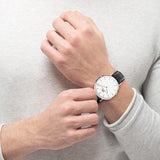Man wearing a black leather watch, 550x733.