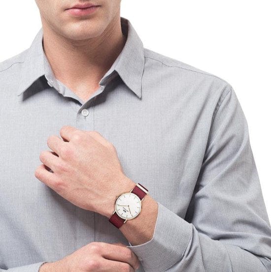 Man wearing watch with red and white band