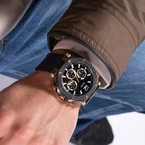 Guess watch on wrist - black and gold chronograph
