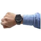 Man's wrist wearing a black watch, style 61_y99s0jML.