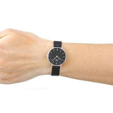 Wrist with black watch.