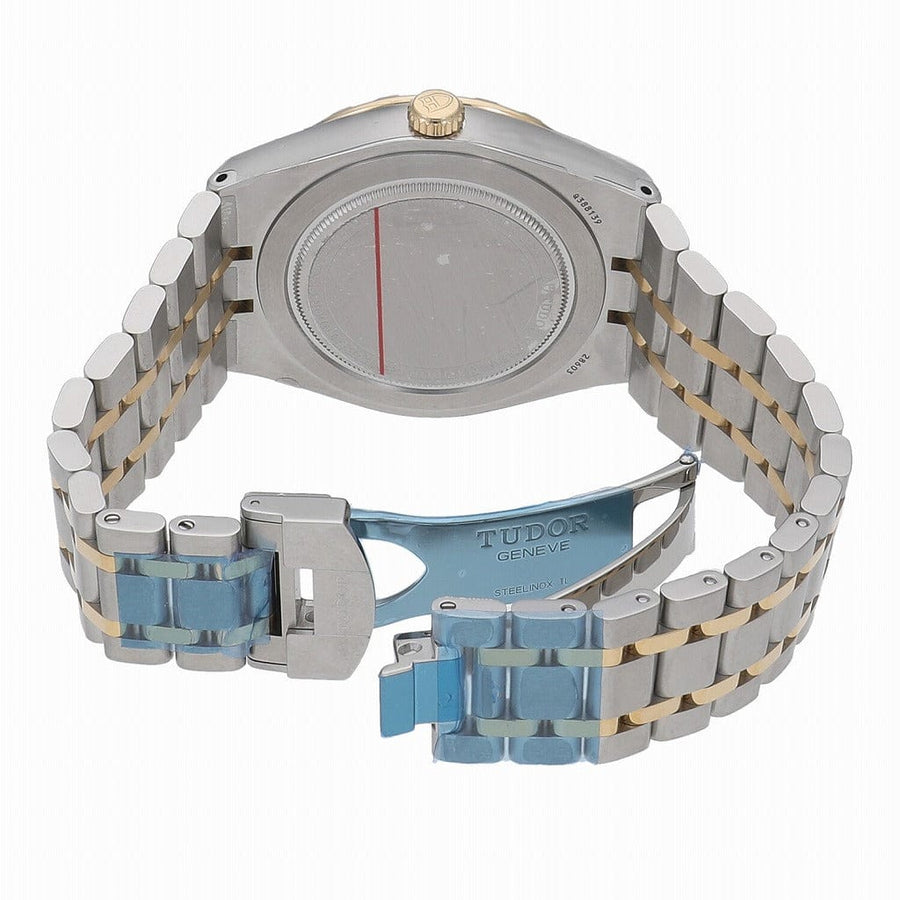 Back of a silver and gold wristwatch.