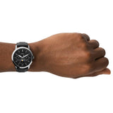 Fossil watch 71f5f75FS5904 on wrist, black leather strap.