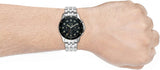 Man wearing a silver watch on wrist.