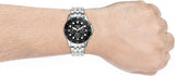 Silver watch on wrist, product image.