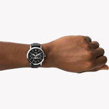 Man wearing Fossil watch with black leather strap