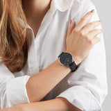 Woman wearing a black watch.
