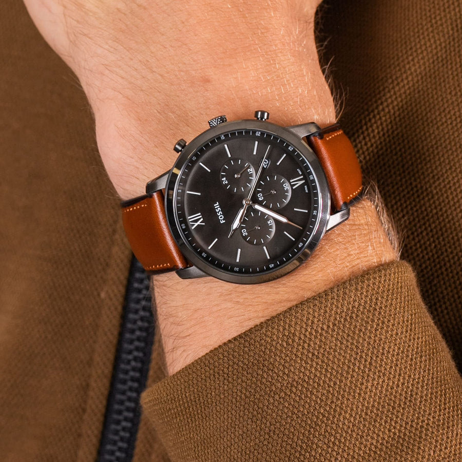 Fossil watch on wrist with brown leather band
