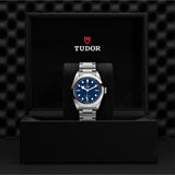 Tudor watch in black display case.