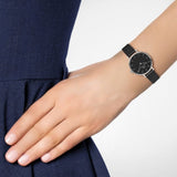 Woman wearing black wristwatch