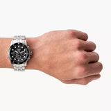Fossil watch 8886010-3 on wrist, stainless steel and black face.