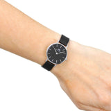 Wrist with a black watch.